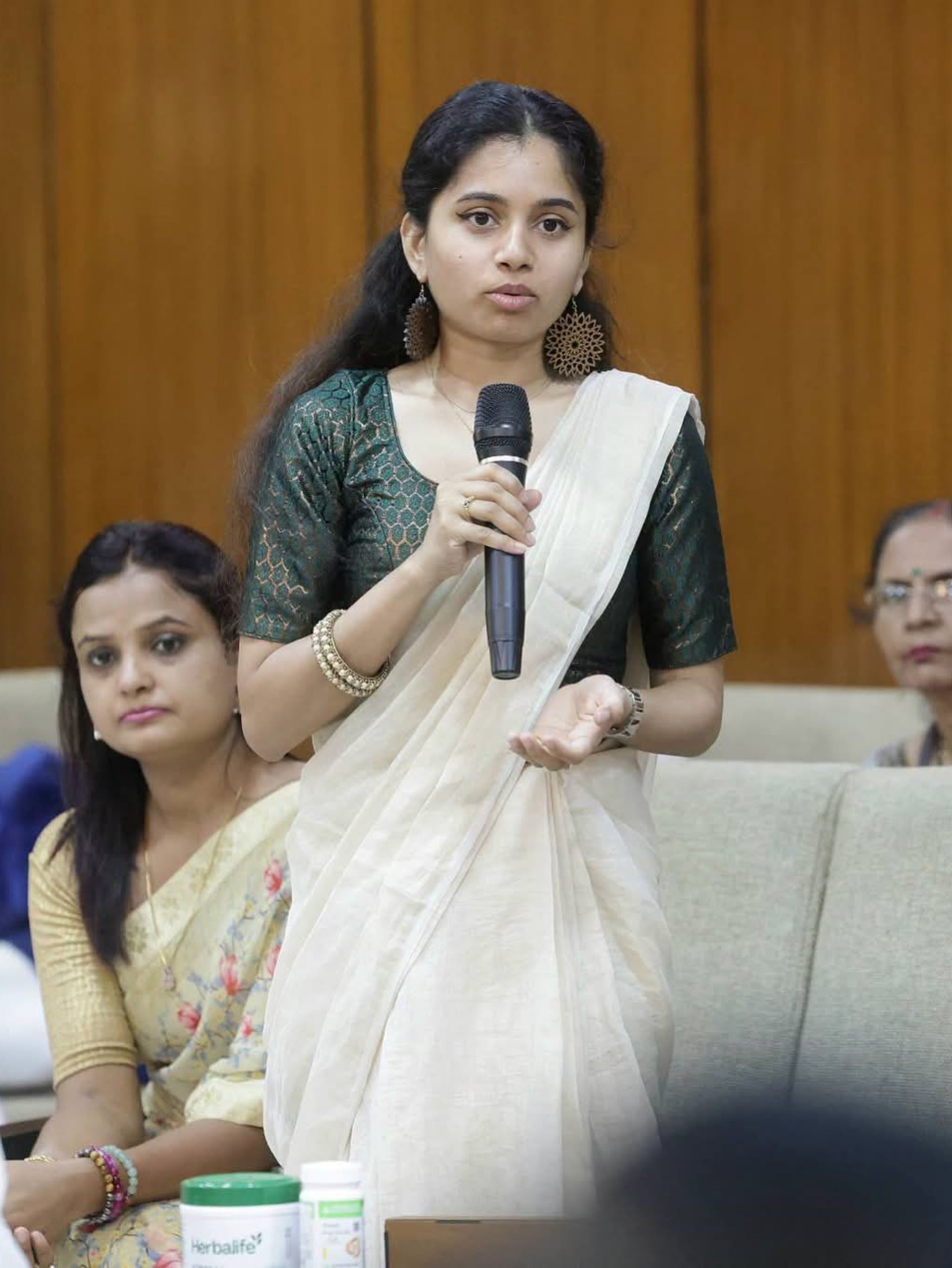 Aditi Abraham pitching AD'NOVEL with a microphone