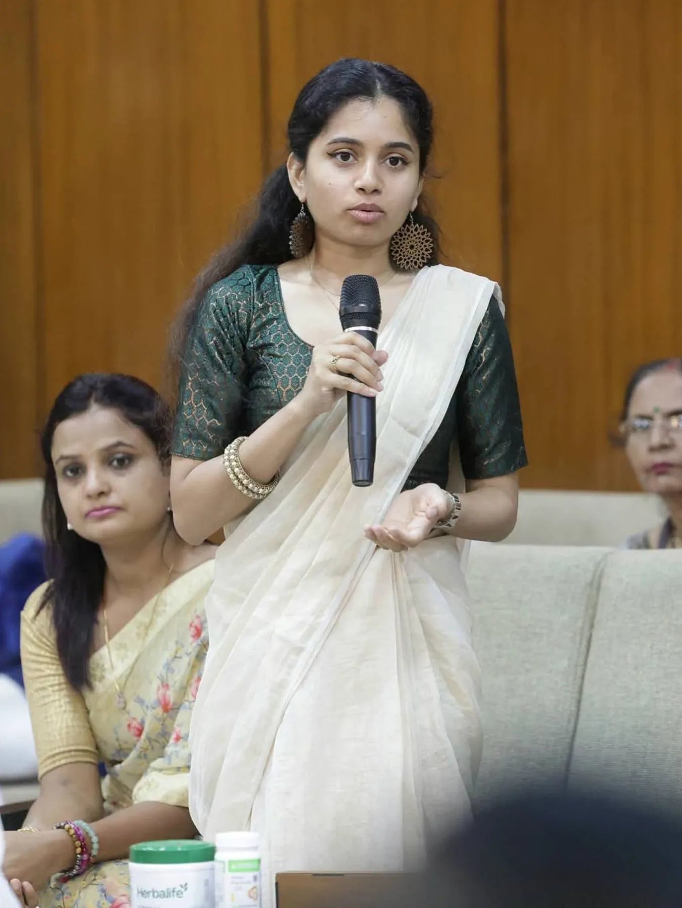 Aditi Abraham pitching AD'NOVEL with a microphone