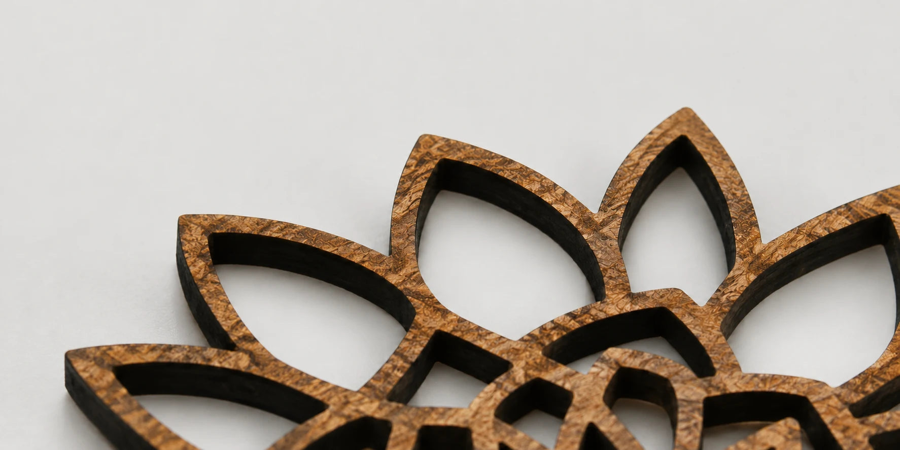Close detail of a handcrafted wooden flower with openwork petals